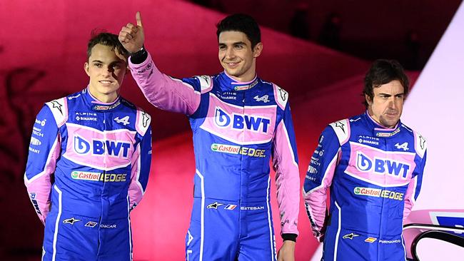 (From L) Alpine F1 team's drivers, Australian Oscar Piastri, French Esteban Ocon and Spanish Fernando Alonso, pose during the unveiling of Alpine F1 team's A522 new racing car for the upcoming Formula One 2022 season at the Palais de Tokyo in Paris on February 21, 2022, two days before the first pre-season track session of the year at the Circuit de Barcelona-Catalunya. - The A522 will be raced this year by Fernando Alonso and Esteban Ocon, whoâll team up for a second season at Alpine. (Photo by FRANCK FIFE / AFP)