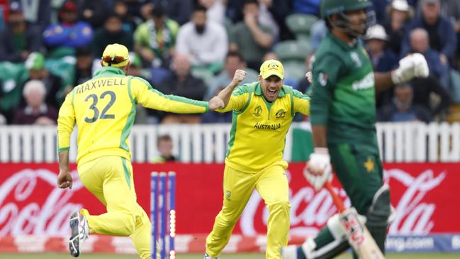 Maxwell runs and celebrates with captain Aaron Finch after running out Sarfaraz Ahmed. Picture: AP