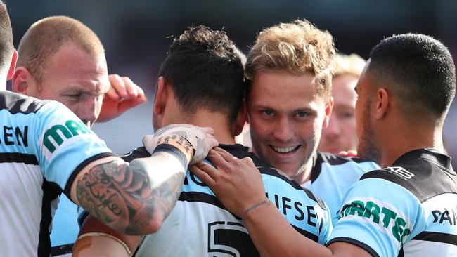 Sharks players celebrate a try against the Knights.