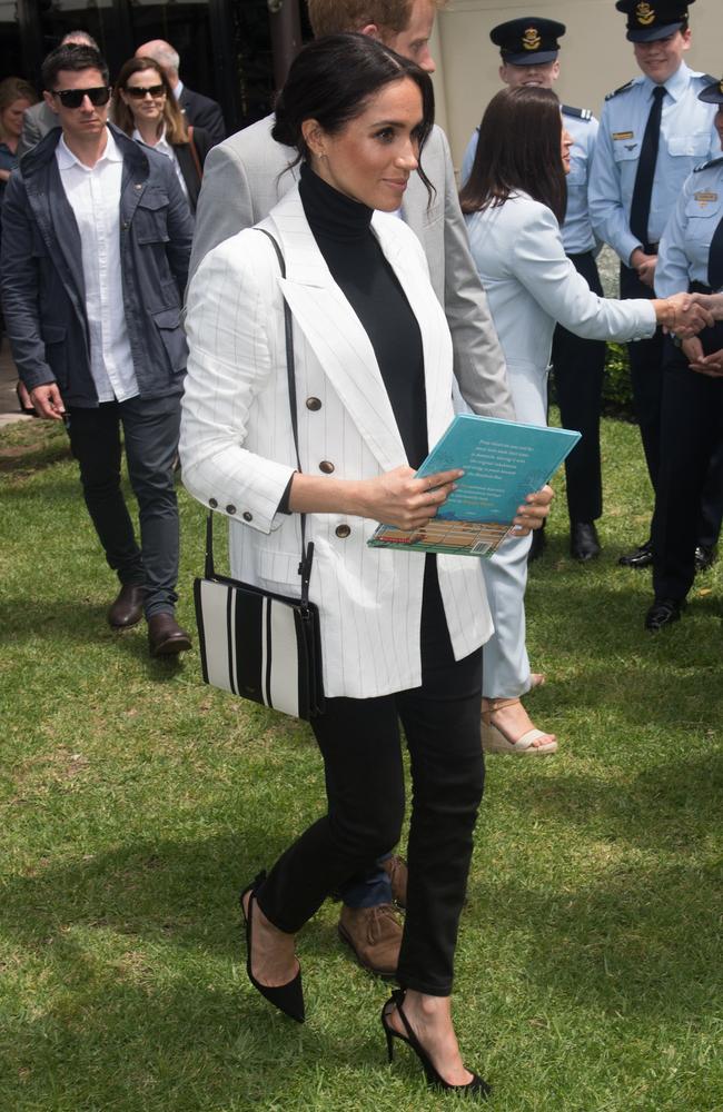 Meghan goes with a L’Agence blazer, jeans and heels on day 6 of the royal tour.