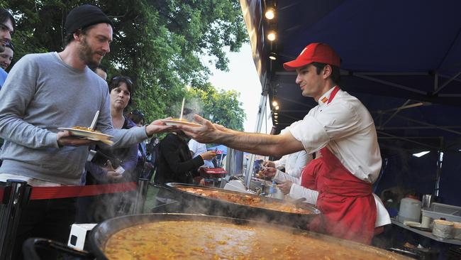 Brunswick’s Domenic Ford buys paella at the Spanish Gourmet Caterers' stall at the Coburg Night Market in 2010.