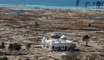 (FILES) This aerial file photo taken on January 16, 2005 shows a partly damaged mosque in the Lampuuk coastal district of Banda Aceh on Indonesia's Sumatra island, an area which was devastated in the earthquake and tsunami on December 26, 2004. Indonesia will mark on December 26, 2014 the 10th year anniversary of the deadly tsunami which killed more than 170,000 people in Aceh, and tens of thousands of others in other countries around the Indian Ocean. AFP PHOTO / FILES / JOEL SAGET