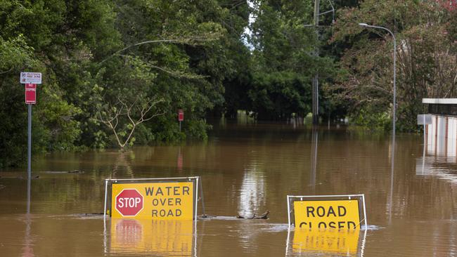 Flood sign on a road under water near the Lismore, NSW, central business district.