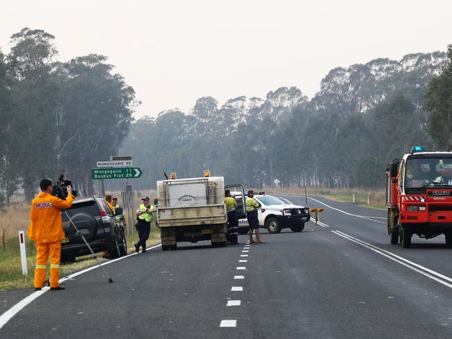 A roadblock due to bushfires near Busbys Flat, northern NSW, Wednesday, October 9, 2019. Fire warnings are in place across parts of northern NSW as out-of-control blazes continue to burn. Up to 30 homes have been lost as bushfires ravaged parts of northern NSW on Tuesday, with the village of Rappville particularly affected. (AAP Image/Jason O'Brien)