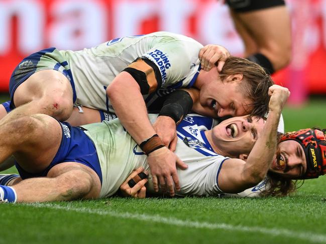 BRISBANE, AUSTRALIA - JULY 27: Connor Tracey of the Bulldogs celebrates with team mates after scoring a try during the round 21 NRL match between Brisbane Broncos and Canterbury Bulldogs at Suncorp Stadium, on July 27, 2024, in Brisbane, Australia. (Photo by Albert Perez/Getty Images)