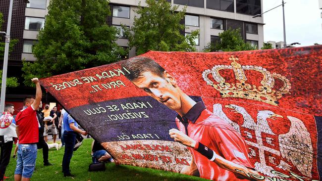 People hold placards at the detention centre where Novak Djokovic is being held. Picture: AFP.