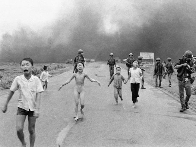 South Vietnamese forces follow after terrified children, including 9-year-old Kim Phuc, center, as they run down Route 1 near Trang Bang after an aerial napalm attack on suspected Viet Cong hiding places, June 8, 1972. A South Vietnamese plane accidentally dropped its flaming napalm on South Vietnamese troops and civilians. The terrified girl had ripped off her burning clothes while fleeing. The children from left to right are: Phan Thanh Tam, younger brother of Kim Phuc, who lost an eye, Phan Thanh Phouc, youngest brother of Kim Phuc, Kim Phuc, and Kim's cousins Ho Van Bon, and Ho Thi Ting. Behind them are soldiers of the Vietnam Army 25th Division. (AP Photo/Nick Ut)