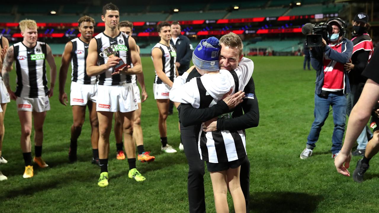 The Collingwood legend shares a special moment post-game with his son, Ayce. Picture: Phil Hillyard