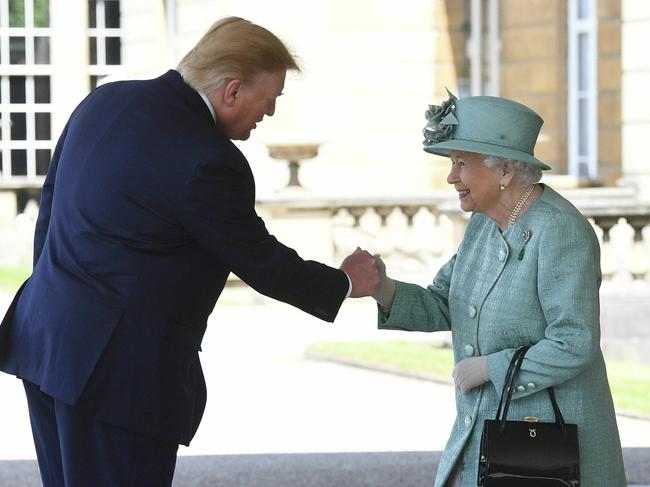 Britain's Queen Elizabeth II greets President Donald Trump as he arrives for a welcome ceremony in the garden of Buckingham Palace. Picture: AP