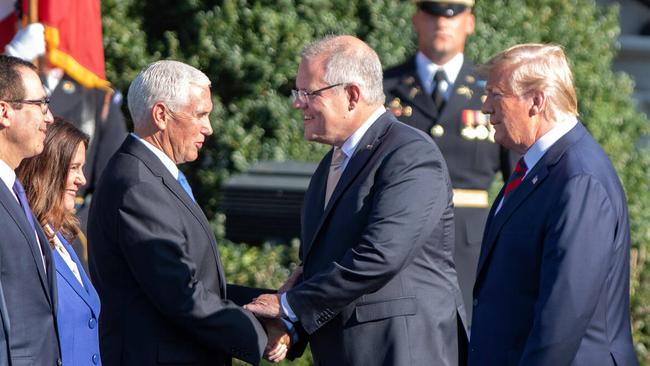 Mike Pence shakes hands with Morrison as President Trump looks on. Picture: Alamy Live News