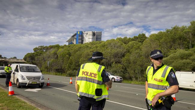 Police directing cars from New South Wales at a border checkpoint. Picture: Glenn Hunt.