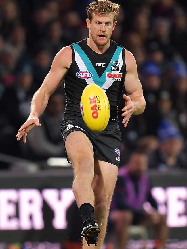 Port Adelaide captain Tom Jonas kicks the ball against the Melbourne Demons at Adelaide Oval. Picture: Daniel Kalisz/Getty