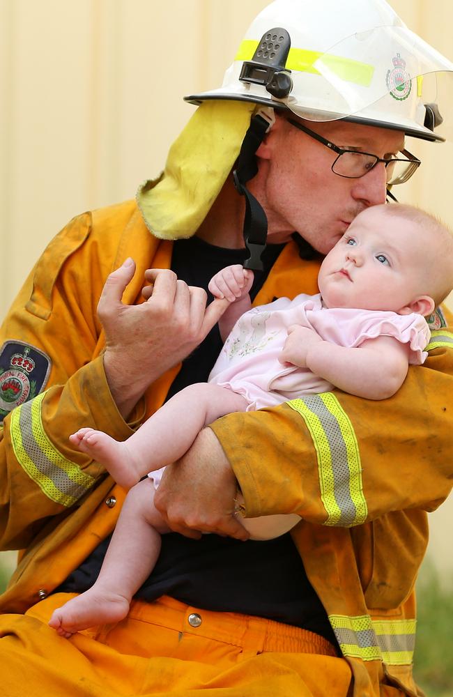 RFS volunteer firefighter Ryan Channells with his three-month-old daughter Skye. Picture: Nathan Edwards