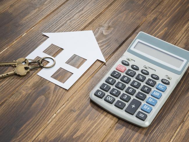 house and key with Calculator on wooden background