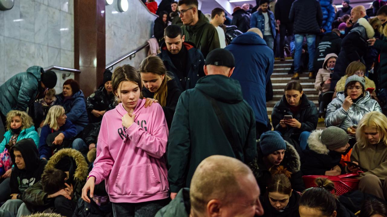 Hundreds of people seek shelter underground, on the platform, inside the dark train cars, and even in the emergency exits, in metro subway station as the Russian invasion of Ukraine continues, in Kharkiv, Ukraine, (MARCUS YAM / LOS ANGELES TIMES)