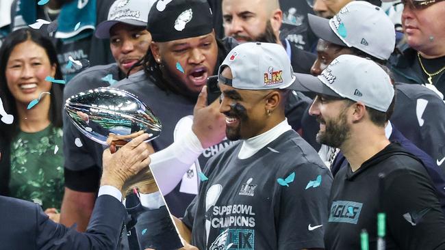 NEW ORLEANS, LOUISIANA - FEBRUARY 09: Philadelphia Eagles owner Jeffrey Lurie hands the Vince Lombardi Trophy to Jalen Hurts #1 after beating the Kansas City Chiefs 40-22 to win Super Bowl LIX at Caesars Superdome on February 09, 2025 in New Orleans, Louisiana. (Photo by Chris Graythen/Getty Images)