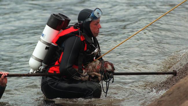 Police divers retrieve a crowbar and blanket material out of Blue Rock Lake, Moe.