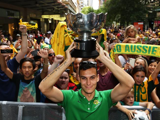 Australia's Trent Sainsbury holds the Asian Cup after the Socceroos 2015 Asian Cup win during a public celebration in Pitt St Mall, Sydney. Pic Brett Costello