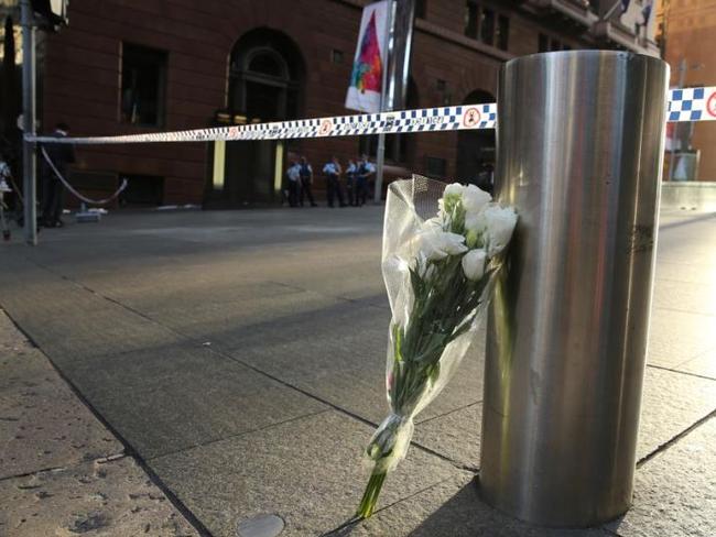 The first of the floral tributes stands alone at Martin Place at 5.45am yesterday / Picture: John Grainger