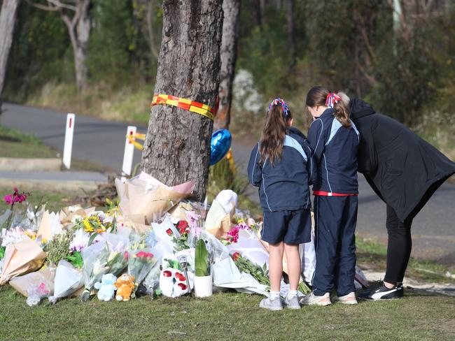 Friends pay their respects at a memorial of flowers dedicated to the five teens killed in a car crash at Buxton. Picture: John Grainger