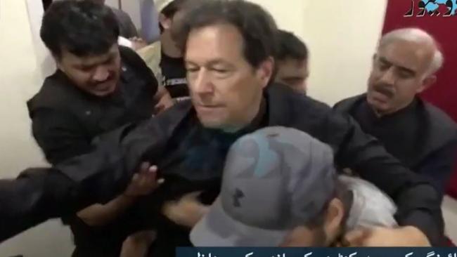 Former Pakistani PM Imran Khan being supported after the attack