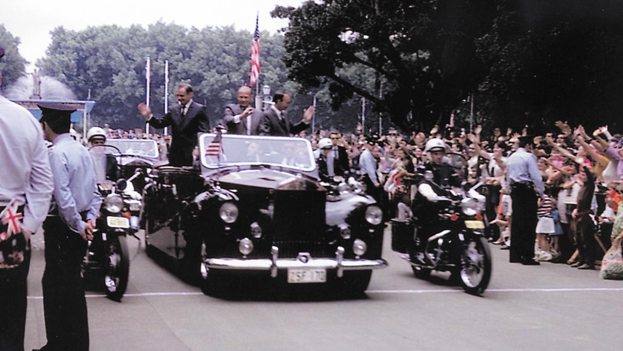 Neil Armstrong, left, Edwin ‘Buzz’ Aldrin and Michael Collins ride in a motorcade past Hyde Park, Sydney, in November 1969. Picture: Tom Jenner