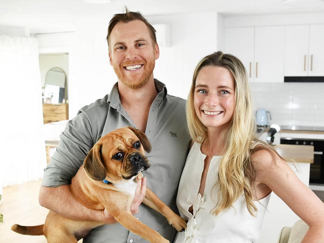 Scott Smith and Michaela Krass are renting a beachside apartment on the Sunshine Coast and leasing out two units they own in the outer Brisbane suburbs. Pictured with their dog Feta. Photo: Patrick Woods.