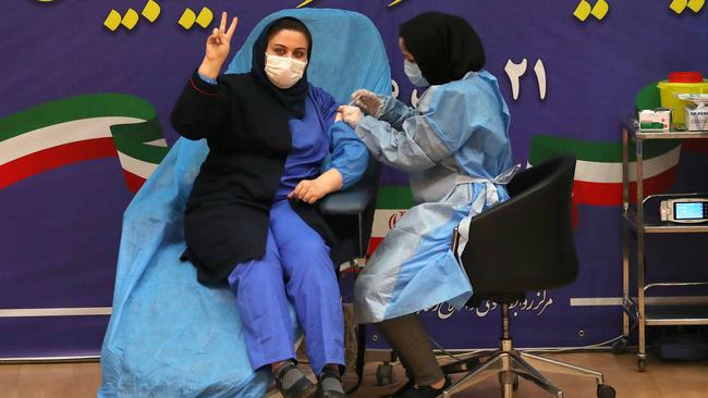 Iranian health worker Sara Gudarzi receives the COVID-19 vaccine as the country launches its inoculation campain in Tehran this week. Picture: AFP