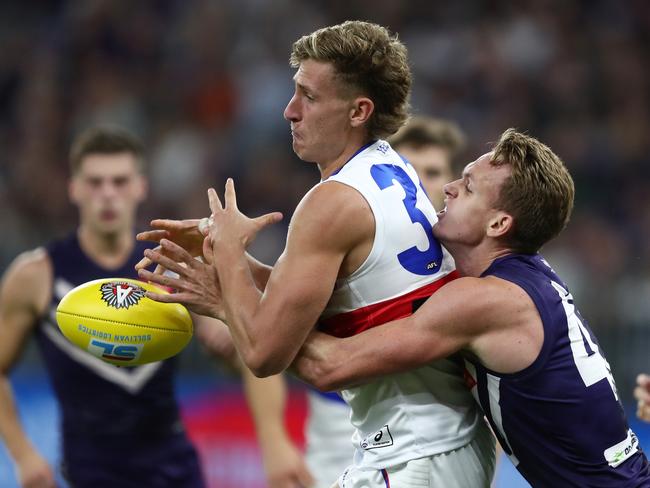 Aaron Naughton of the Bulldogs is tackled by Ryan Nyhuis of the Dockers during the Round 6 AFL match between the Fremantle Dockers and the Western Bulldogs  at Optus Stadium in Perth, Saturday, April 27, 2019.  (AAP Image/Gary Day) NO ARCHIVING, EDITORIAL USE ONLY