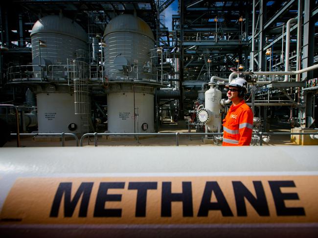 A worker walks past a gas pipe marked "Methane" at the Curtis Island liquefied natural gas (LNG) plant, a part of the Queensland Curtis Liquefied Natural Gas (QCLNG) project site operated by QGC Pty, a unit of Royal Dutch Shell Plc, in Gladstone, Australia, on Wednesday, June 15, 2016. Gas from more than 2,500 wells travels hundreds of miles by pipeline to the project, where it's chilled and pumped into 10-story-high tanks before being loaded onto massive ships. Photographer: Patrick Hamilton/Bloomberg