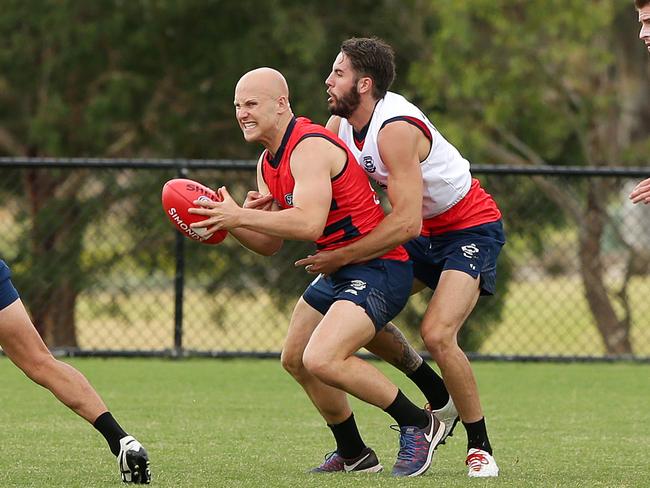 Gary Ablett tries to break a James Parsons tackle at a wet Geelong training session. Picture: Alison Wynd