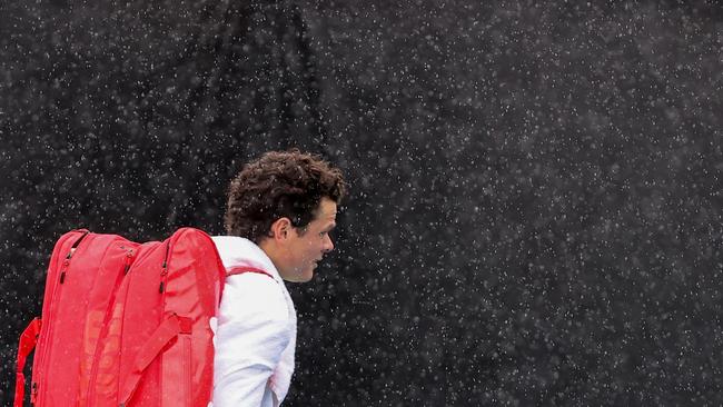 Milos Raonic walks off court during a rain delay. Picture: David Gray/AFP