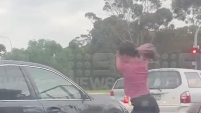 A shocking road rage attack has been captured on camera at Elizabeth, Adelaide, showing a woman kicking a side mirror before using it to smash a driver’s window. Picture: 9News,
