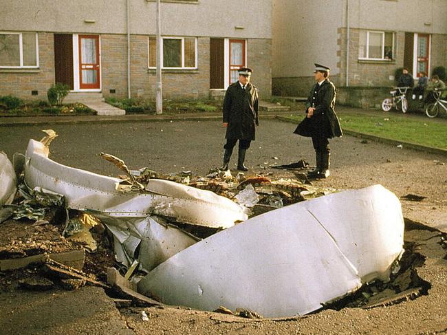 Police by the wreckage of the Pan Am Boeing 747 crashed into Lockerbie after a bomb on board exploded.