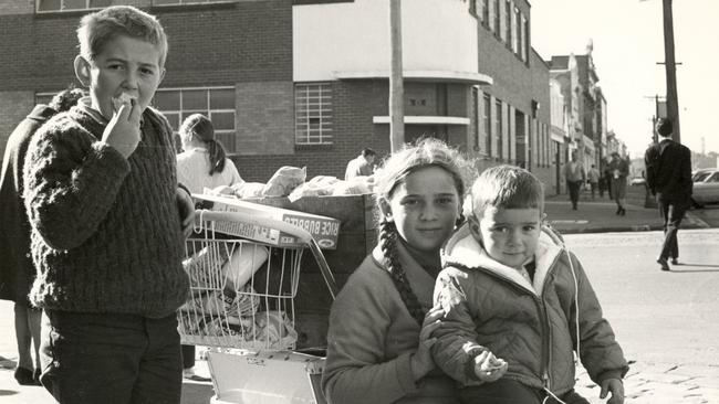 Siblings stop for a moment at the market during the 1960s to 70s. Supplied image from the City of Port Phillip Collection