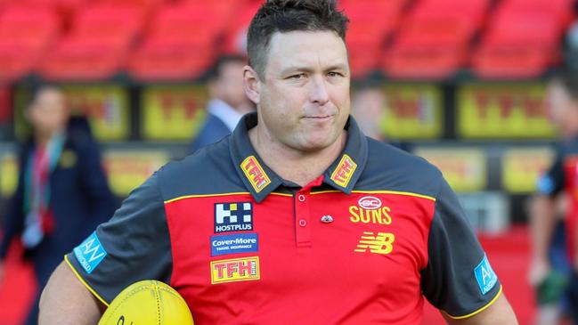 GOLD COAST, AUSTRALIA - APRIL 24: Stuart Dew, Senior Coach of the Suns enters the field during the 2022 AFL Round 06 match between the Gold Coast Suns and the Brisbane Lions at Metricon Stadium on April 24, 2022 in the Gold Coast, Australia. (Photo by Russell Freeman/AFL Photos via Getty Images)