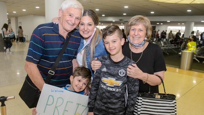 Carla (centre) with sons Dion and Levi welcome Paul and Bruna Battistella at Melbourne Airport. Picture: Jay Town