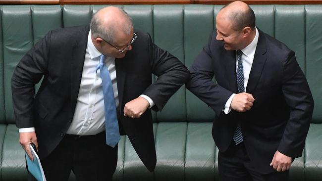 Scott Morrison and Treasurer Josh Frydenberg swap the handshake for the elbow tap in the House of Representatives on Wednesday. Picture: Getty Images