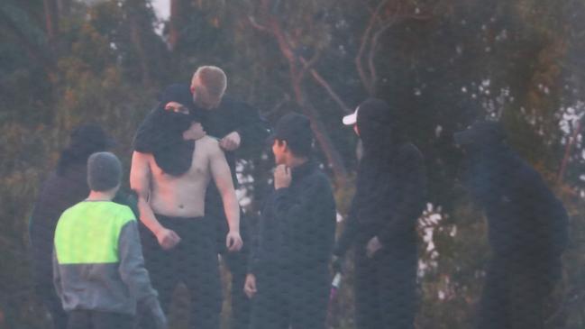 Inmates from the Frank Baxter Juvenile corrections centre Kariong  taunt police from the roofs of various buildings . Some are armed with poles tennis rackets ect .picture John Grainger