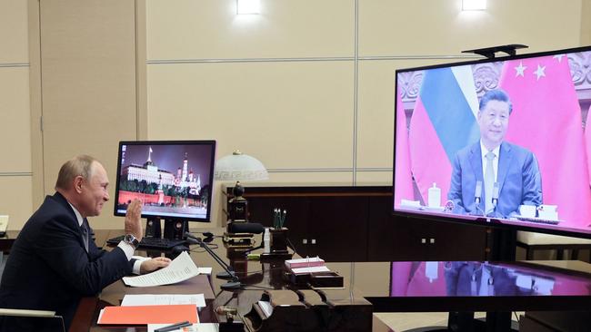 Russian President Vladimir Putin holds a meeting with Chinese President Xi Jinping via a video link at the Novo-Ogaryovo state residence. Picture: AFP.