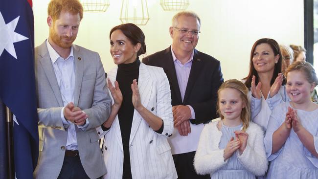 Harry and Meghan with PM Scott Morrison and his wife Jenny and daughters Lily and Abbey. Picture: Justin Lloyd.