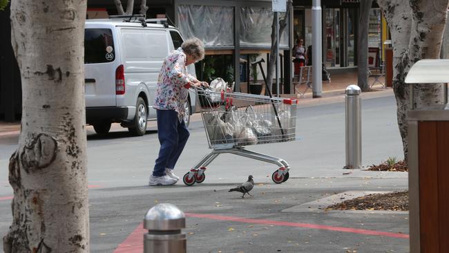 A woman takes her shopping home on Nerang Street. Picture Glenn Hampson