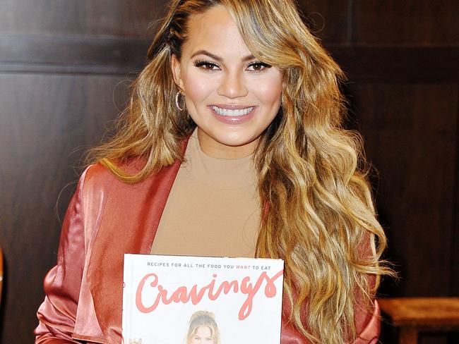 Teigen signs copies of her book <i>Cravings</i>.