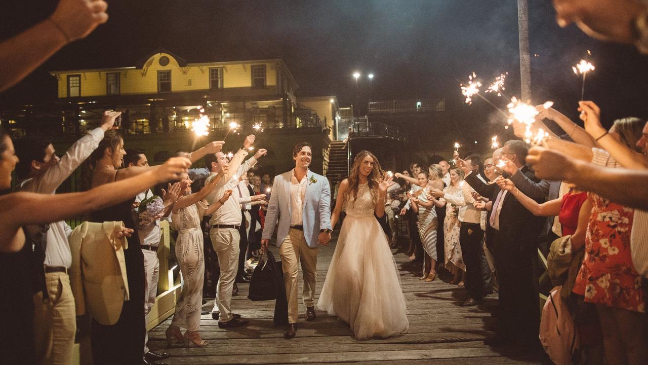 Dani Atkins and Alex Babich on their wedding day, where they said they responded to customer inquiries in the morning.