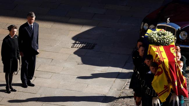 Britain's Princess Anne, Princess Royal (L) and her husband Vice Admiral Timothy Laurence watch as pallbearers carry the coffin of the Queen. Picture: AFP