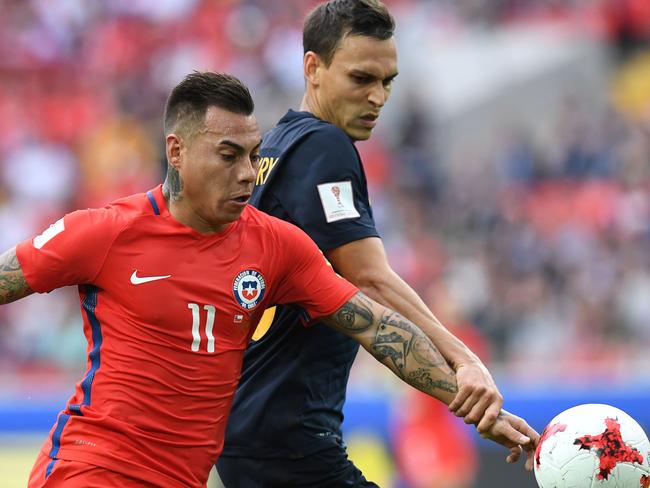 Trent Sainsbury keeps a close eye on Eduardo Vargas.