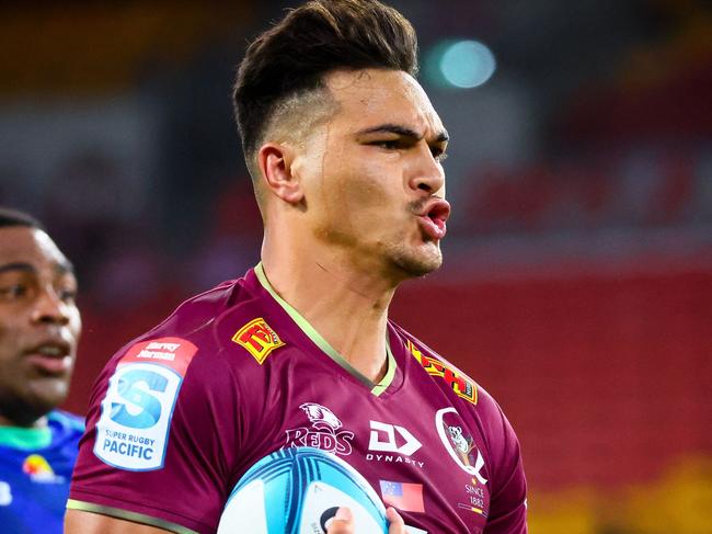 Queensland Reds Jordan Petaia splits the Fiji Drua's defence during the Super Rugby match between the Queensland Reds and Fijian Drua at Suncorp Stadium in Brisbane on March 12, 2022. (Photo by Patrick HAMILTON / AFP) / -- IMAGE RESTRICTED TO EDITORIAL USE - STRICTLY NO COMMERCIAL USE --