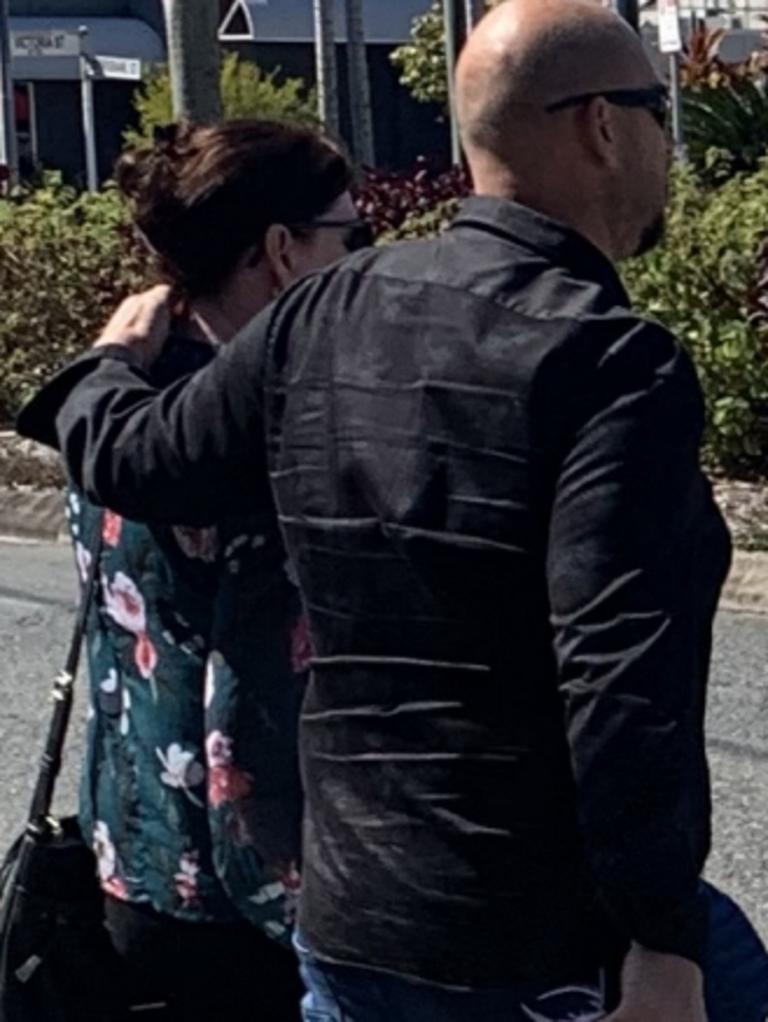 Hospital social worker Sarah Maree Simpson (left) and a man rush from Mackay courthouse after she was fined $2000 and a conviction was recorded for unlawfully accessing a restricted computer.