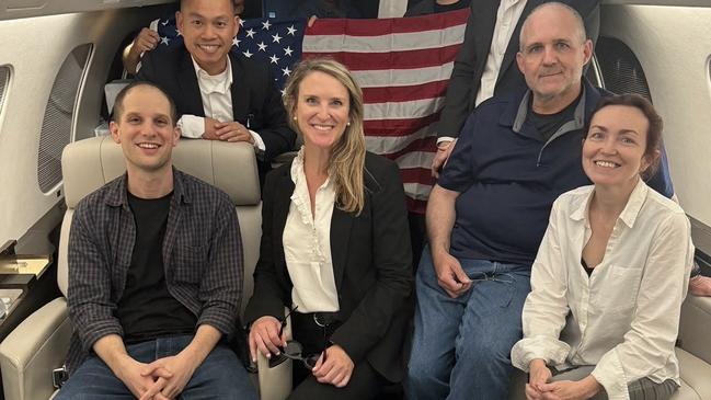 Evan Gershkovich, former US Marine Paul Whelan, second right, and Alsu Kurmasheva on a plane home after their release from Russian detention: Picture: US government via AFP