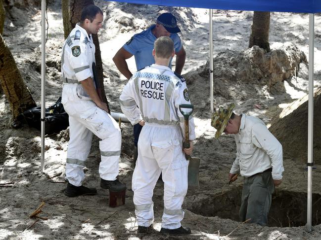 Archaeologist Tony Cowe with police digging in bushland near Magenta. The search is in relation to Ron Penn missing since 1995.